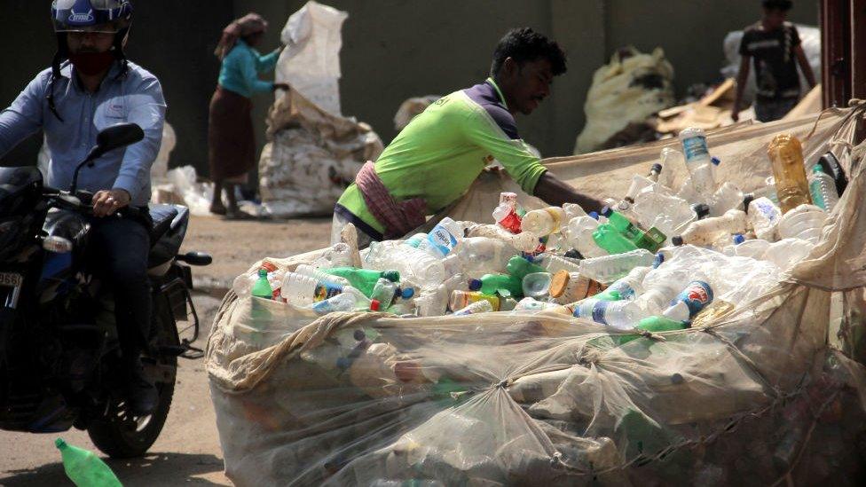 Used plastic bottles are seen at a rag picker unit as it process to supply to the recycled unit