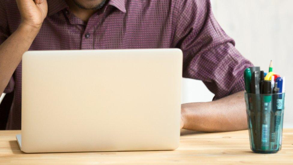 Stock image of man at a computer