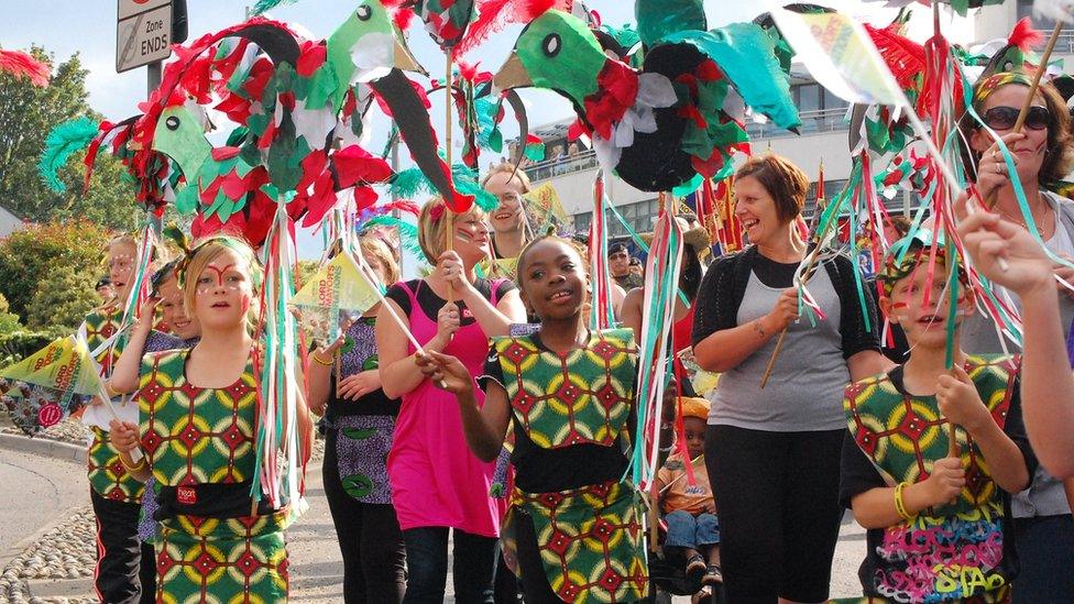 Children and adults in colourful costume walking down St Stephens Street in Norwich during Lord Mayor's Procession in 2011