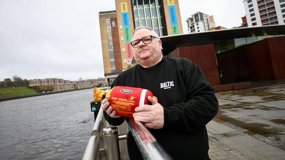 John Dickinson holds a throwline bag next to the Tyne and Baltic