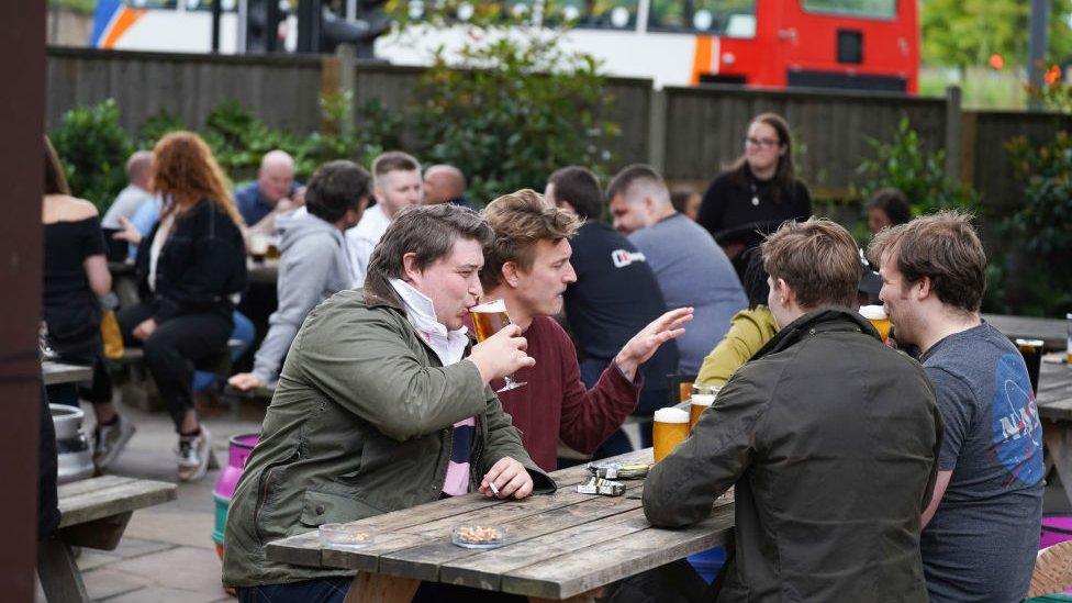 Drinkers outside a pub in Sheffield