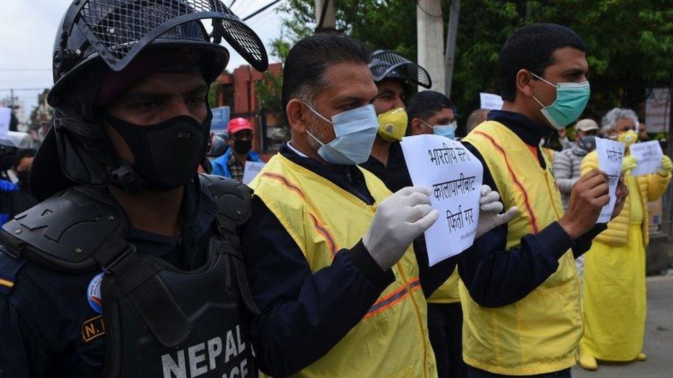 Human rights activists hold placards during a protest against India"s newly inaugurated link road to the Chinese border, near Indian embassy in Kathmandu on May 12, 2020.