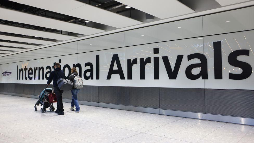 Airline passengers in the arrivals hall at Heathrow Airport in London