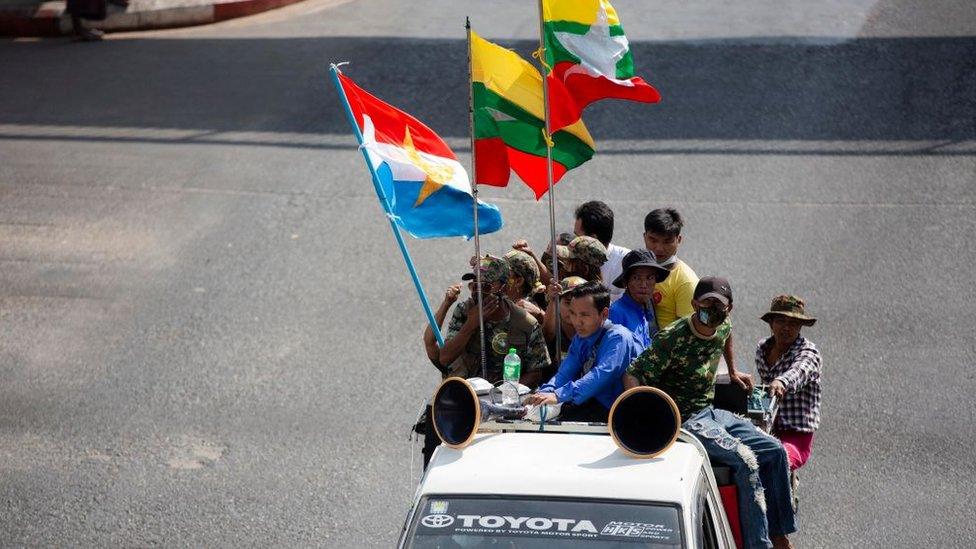 Military supporters drive along the Streets in Yangon.