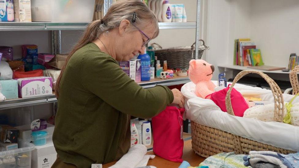 Woman packing Moses basket, the Forge Community Church