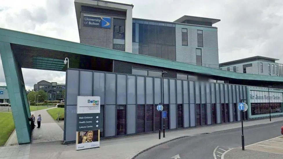 The green and grey exterior of the University of Bolton's Sir Jason Kenny Centre