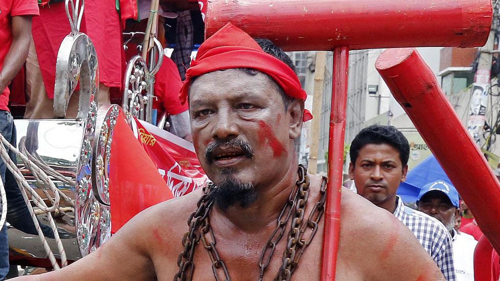 A Bangladeshi worker and activist wears a chain during a rally demanding an increase in minimum wages and safety in the work place during a May Day rally in Dhaka, Bangladesh, 01 May 2018.