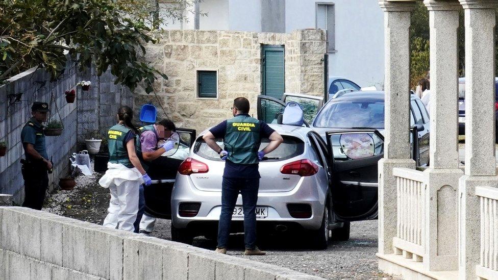 Officers inspect evidence at the scene of a triple murder in the area of Valga in Potevedra, Spain, 16 September 2019