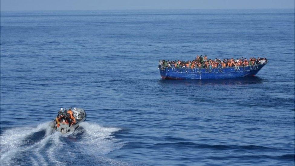 A picture provided by Spanish Ministry of Defence on November 5, 2015 shows Spanish rescuers approaching a boat with migrants off the coast of Libya.