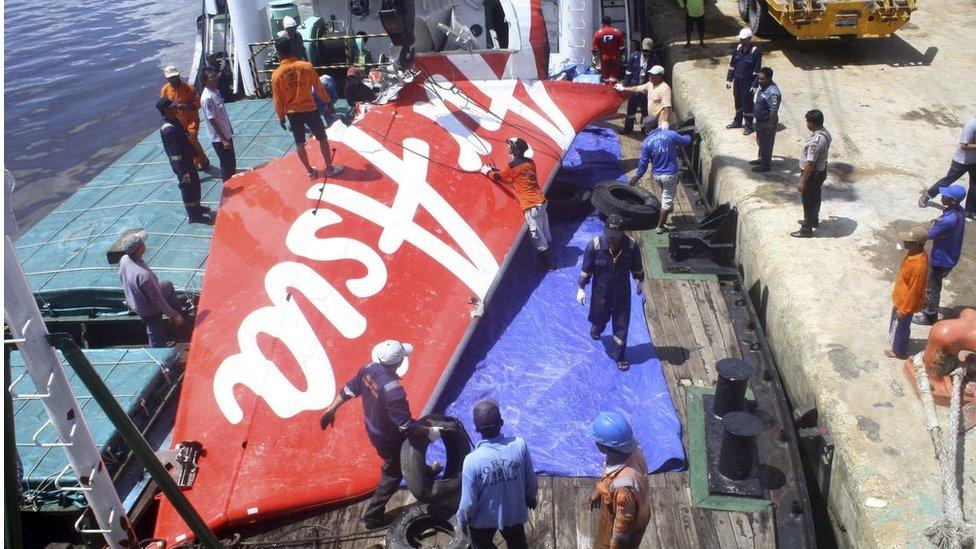 A section of AirAsia flight QZ8501's tail is loaded onto a boat for transportation to Jakarta from Kumai Port, where it had been stored since it was recovered last month, near Pangkalan Bun, Central Kalimantan 7 February 2015 in this file photo taken by Antara Foto.