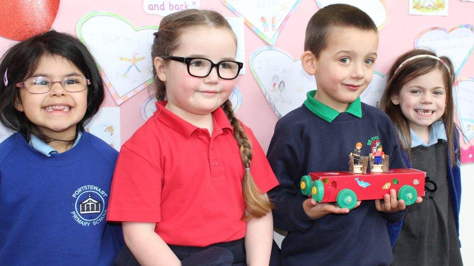 The pupils with one of the completed vehicles