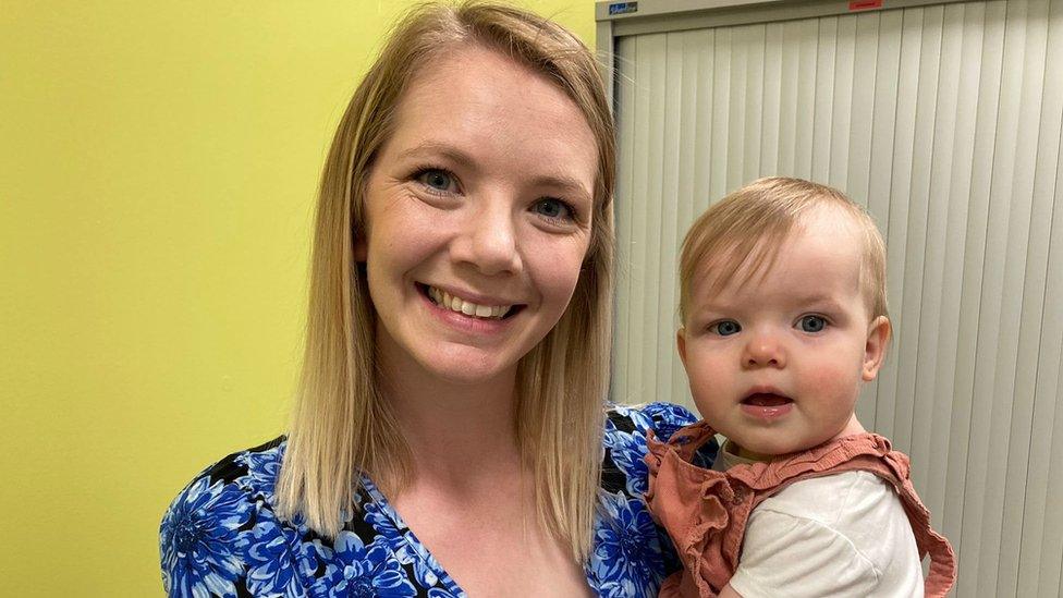 Sophie holds her daughter Darcie