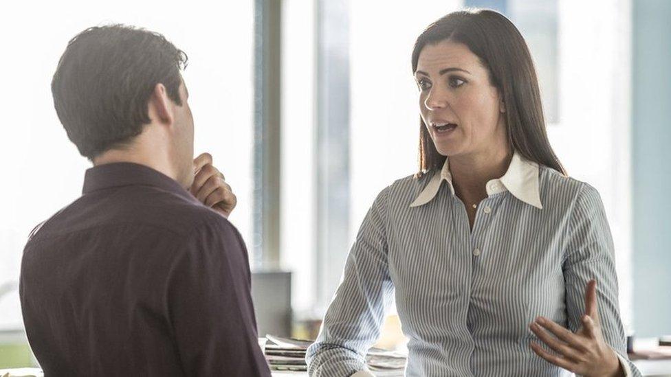 Man and woman talking in an office