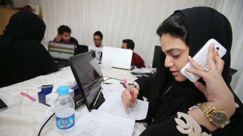 Members of the communication staff for the campagin of a female candiate for the upcoming Saudi municipal elections work hard on contacting and talking to electors