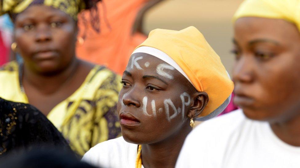 A supporter painted her face during a rally, in Banjul on April 4, 2017