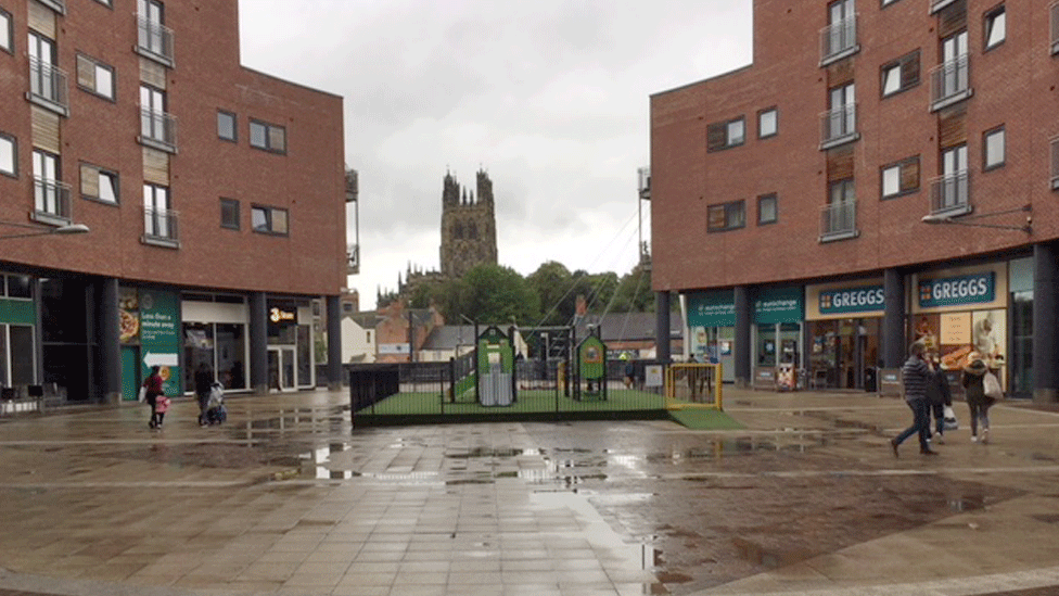 Looking towards Greggs shop and towards Wrexham's St Giles Church which overlooks Eagles Meadows