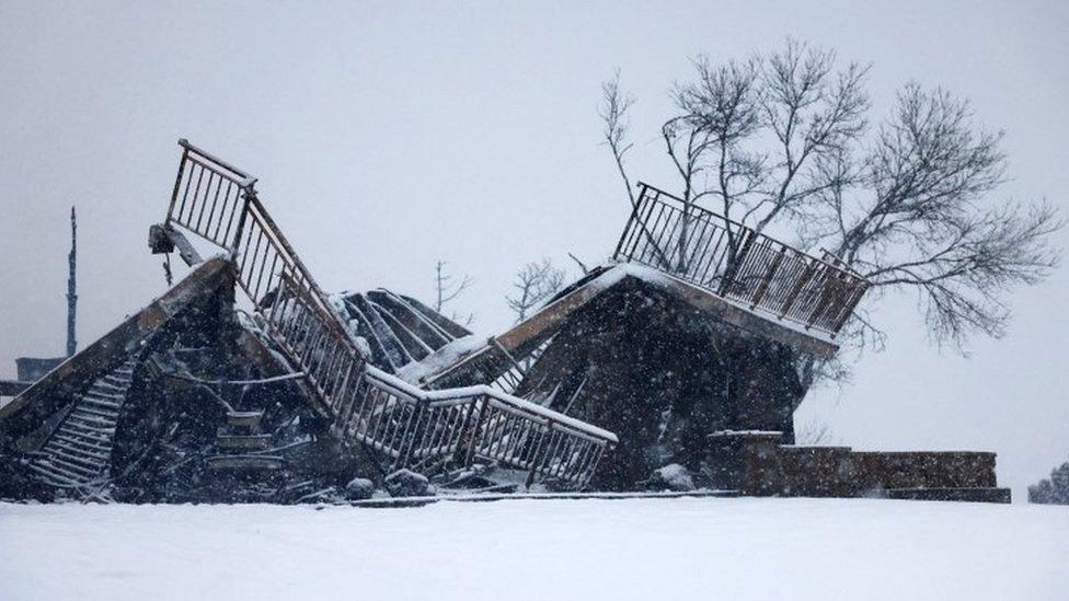 A burned out house buried under snow after a wildfire in Colorado