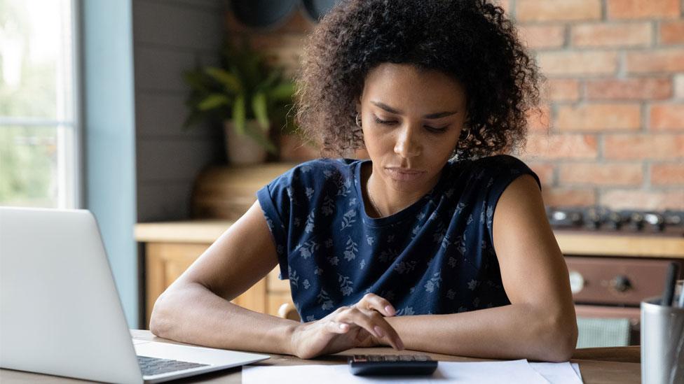 Woman looking at a bill