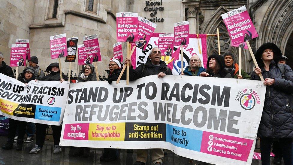 People protest outside the Royal Courts of Justice on Monday