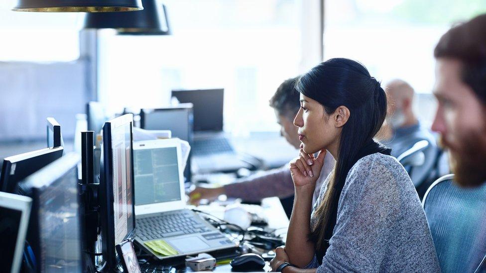 Woman sitting at desk.