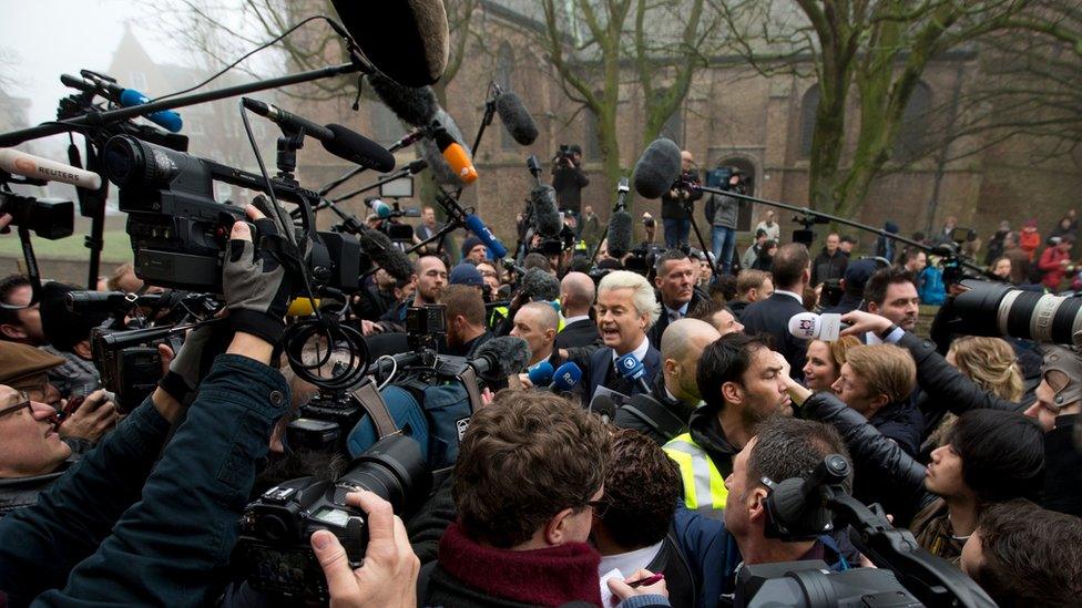 Firebrand anti-Islam lawmaker Geert Wilders, center, talks to the media during an election campaign stop in Spijkenisse, near Rotterdam, Netherlands, Saturday Feb. 18, 2017