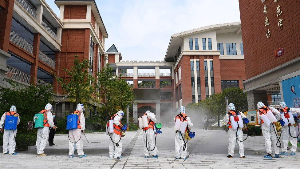 Workers disinfect primary school in Wuhan on 25 August 2021. Photo Barcroft Media