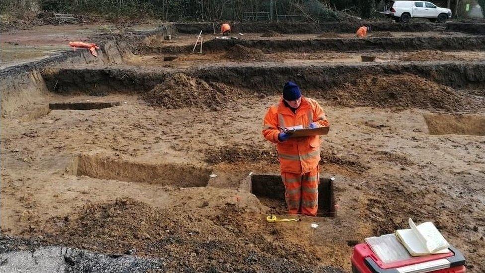 An archaeologist investigating the relationship between two phases of boundaries aligned with the boundary of St Michael’s Church