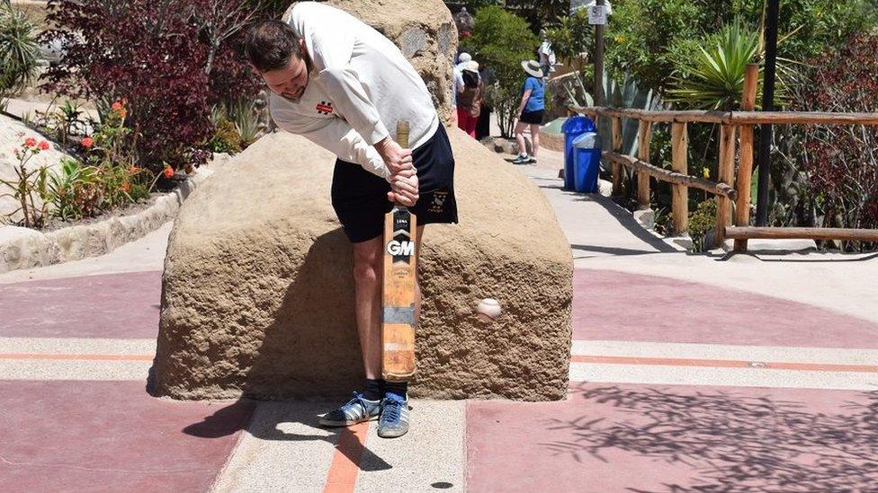 Timothy playing cricket across the line at the equator, Ecuador