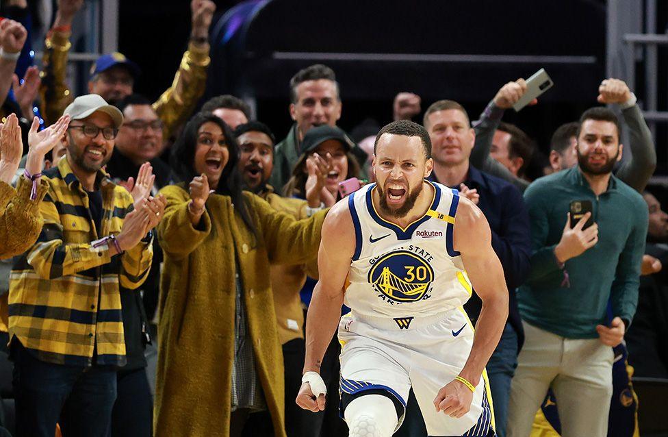 Stephen Curry of the Golden State Warriors reacts after making a basket against the Memphis Grizzlies in the second half of the NBA play-in tournament