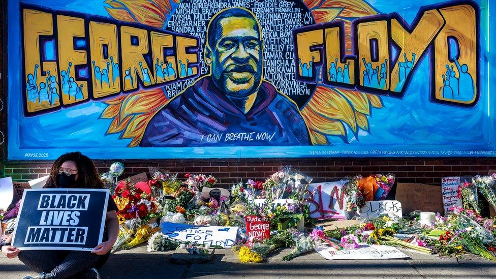 Flowers, signs and balloons are left near a makeshift memorial to George Floyd near the spot where he died while in custody of the Minneapolis police, 29 May 2020