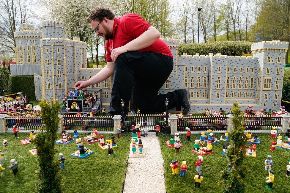 Model maker Francis Carruthers from the Legoland Windsor Resort, places a Lego model of King Charles III into a Windsor Castle concert miniland scene