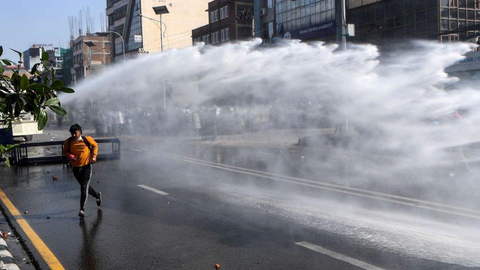 Police use water cannon in an attempt to disperse protesters