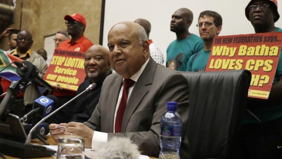 Pravin Gordhan, former South Africa"s finance minister, center, addresses journalists at a joint media conference