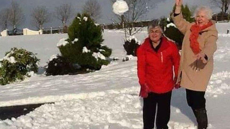 Enid Williamson and Myrtle Gibb get in a spot of snowballing in Dromore, County Down