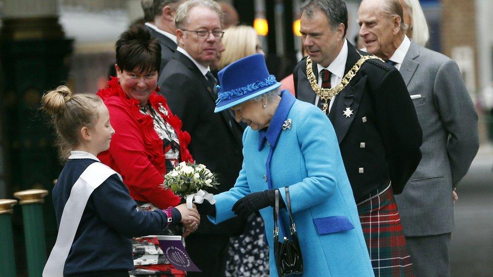 Queen accepts a posy of flowers