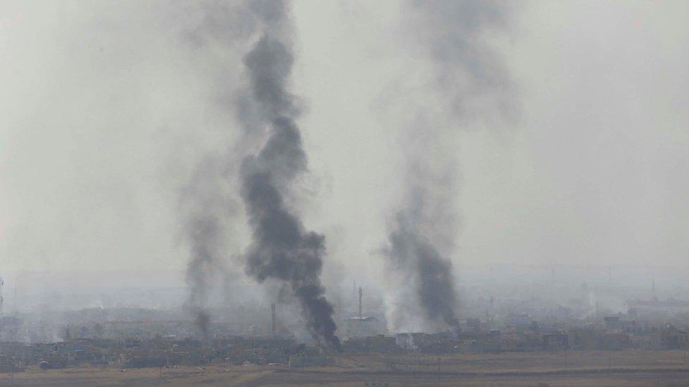 Smoke rises from near Bartella, east of Mosul, during clashes between Iraqi government forces and Islamic State militants on 18 October 2016