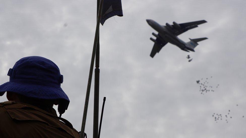 A UN soldier monitors an airdop