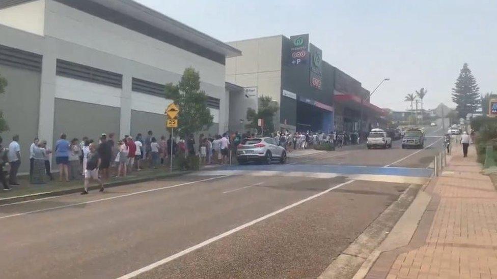 A long queue forms at a Woolworths supermarket in Ulladulla, New South Wales