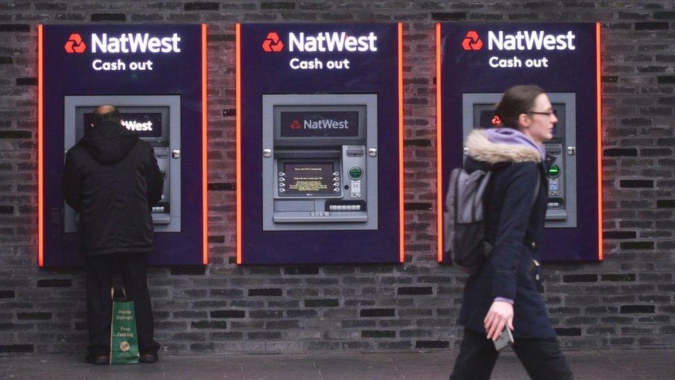 Customers using a NatWest ATM.