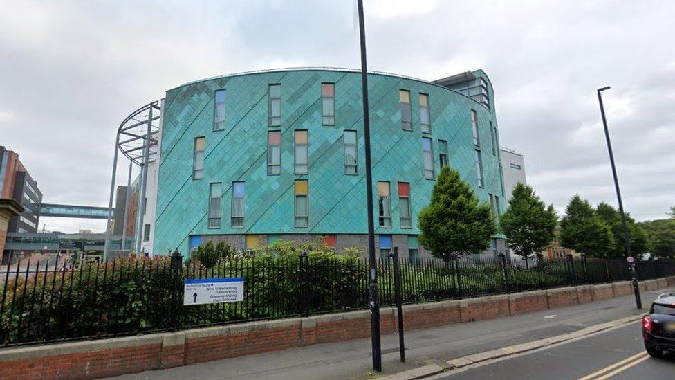 general view of a large green hospital building