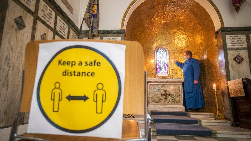 Rev Peter Sutton makes preparations to allow space for private prayer in the Memorial Chapel at St Cuthbert's Parish Church in Edinburgh. Social distancing measures have been put in place at the church, including hand hygiene stations and a one way system.