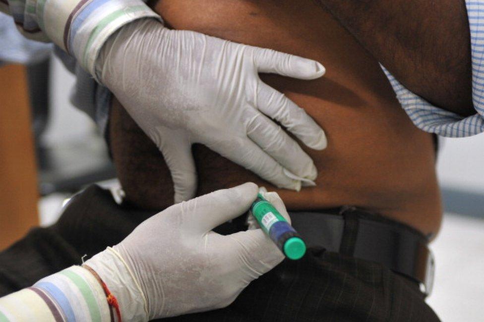 A medical assistant administers an insulin shot to a diabetes patient at a private clinic in New Delhi on November 8, 2011.