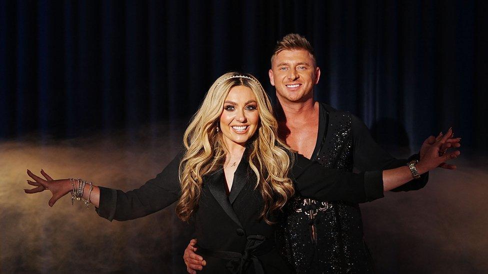 Amy Dowden and firefighter Richard pose in a dance hold