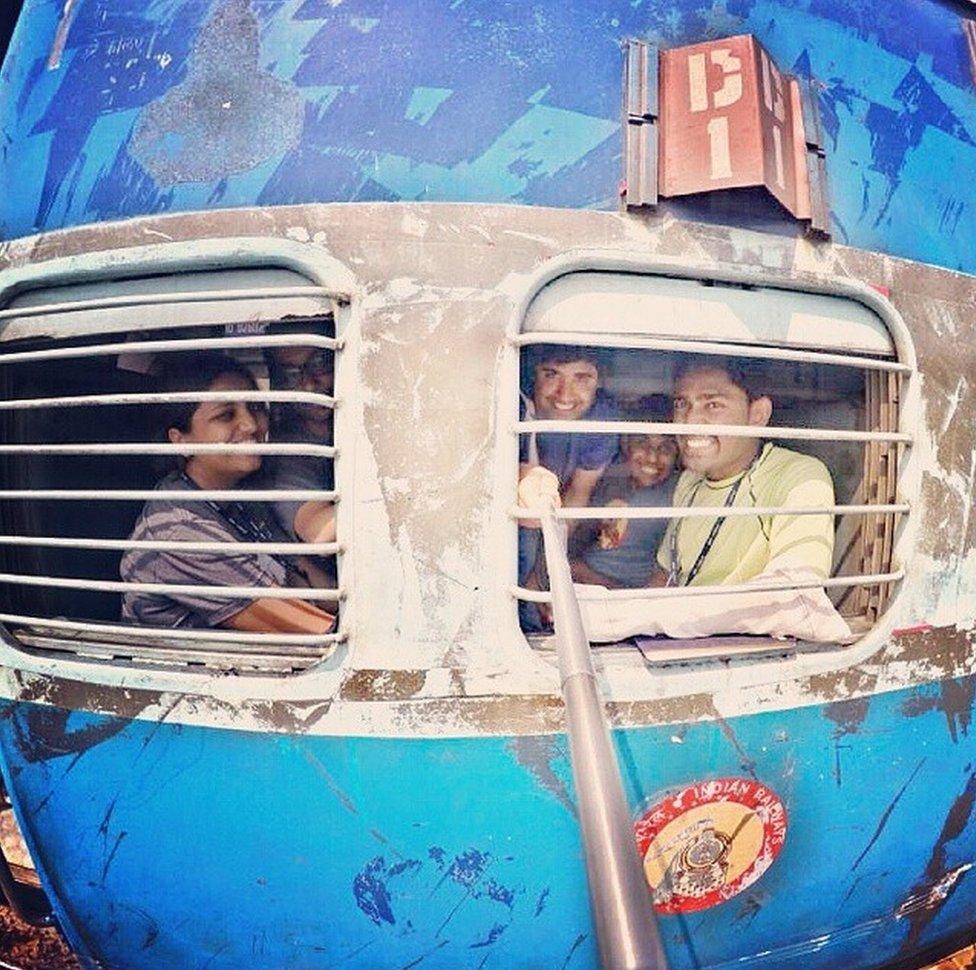 Mr Babar and his friends take a "selfie" while looking out of the window from a train.