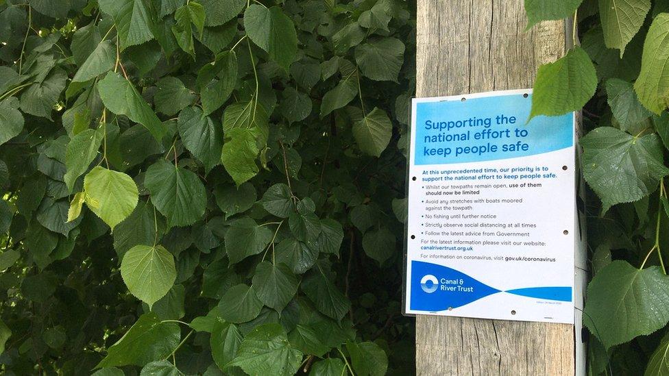 Signs posted by the Canal and River Trust advising people to limit their use of the canals