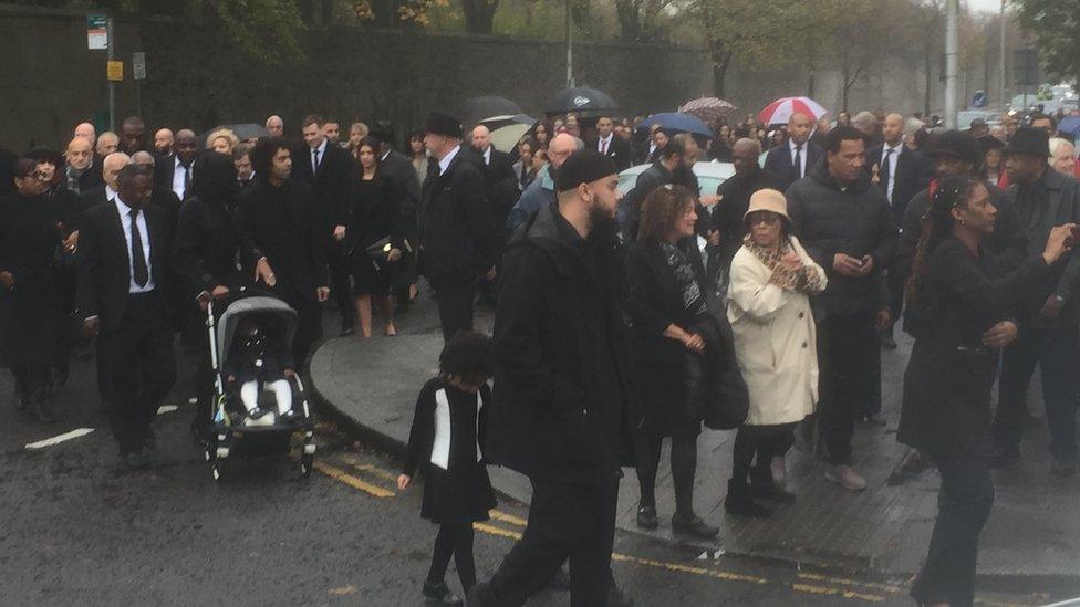 Crowds gather for the funeral of "a true pioneer"