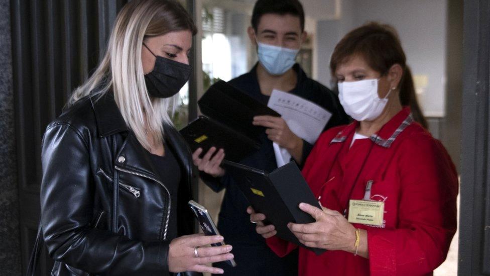 School staff check for "green pass" certificates at a school in Turin, Italy, 13 September 2021