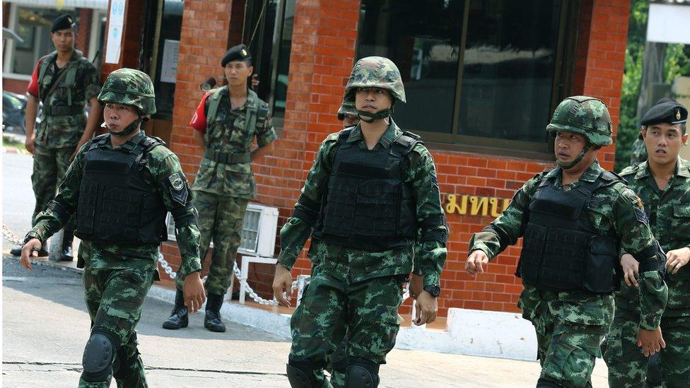 Thai soldiers patrol in front of a military base in Bangkok on 18 April 2016