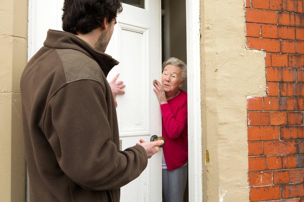 Pushy salesman trying to sell to older woman