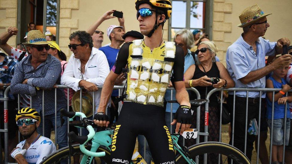 New Zealand's George Bennett (C), wearing a special plastic bib with several pockets filled with ice due to a heatwave in France